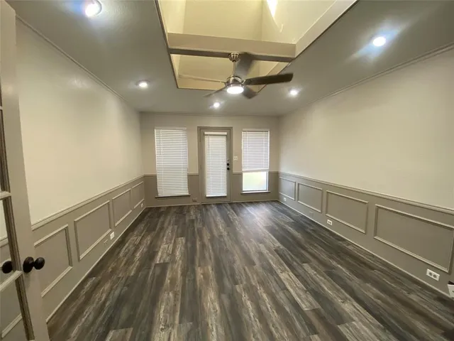 a view of an empty room and wooden floor