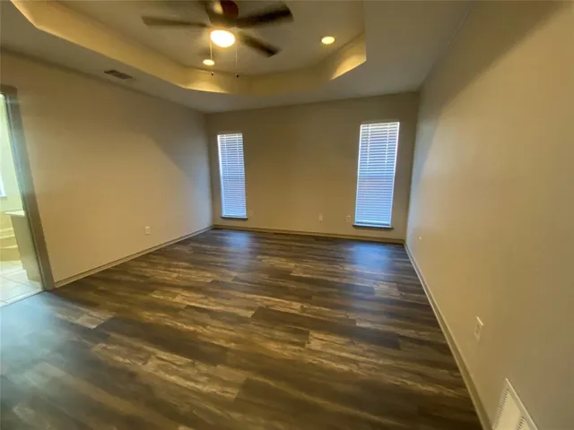 a view of a room with wooden floor