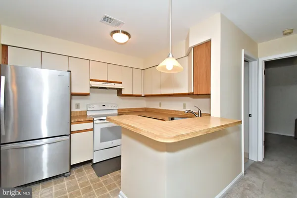 a white refrigerator freezer sitting inside of a kitchen