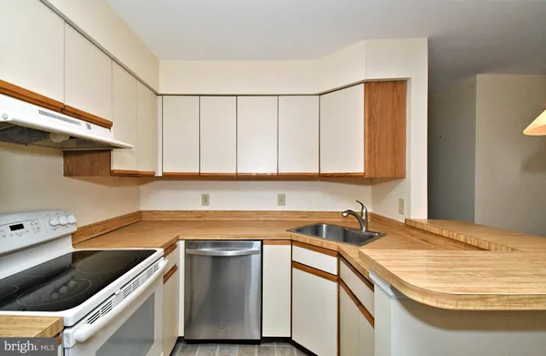 a kitchen with a sink and cabinets