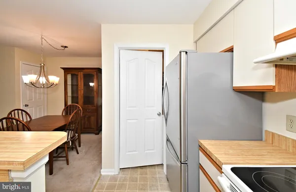 a kitchen with stainless steel appliances a refrigerator stove and cabinets