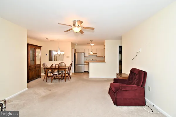 a living room with furniture and kitchen view