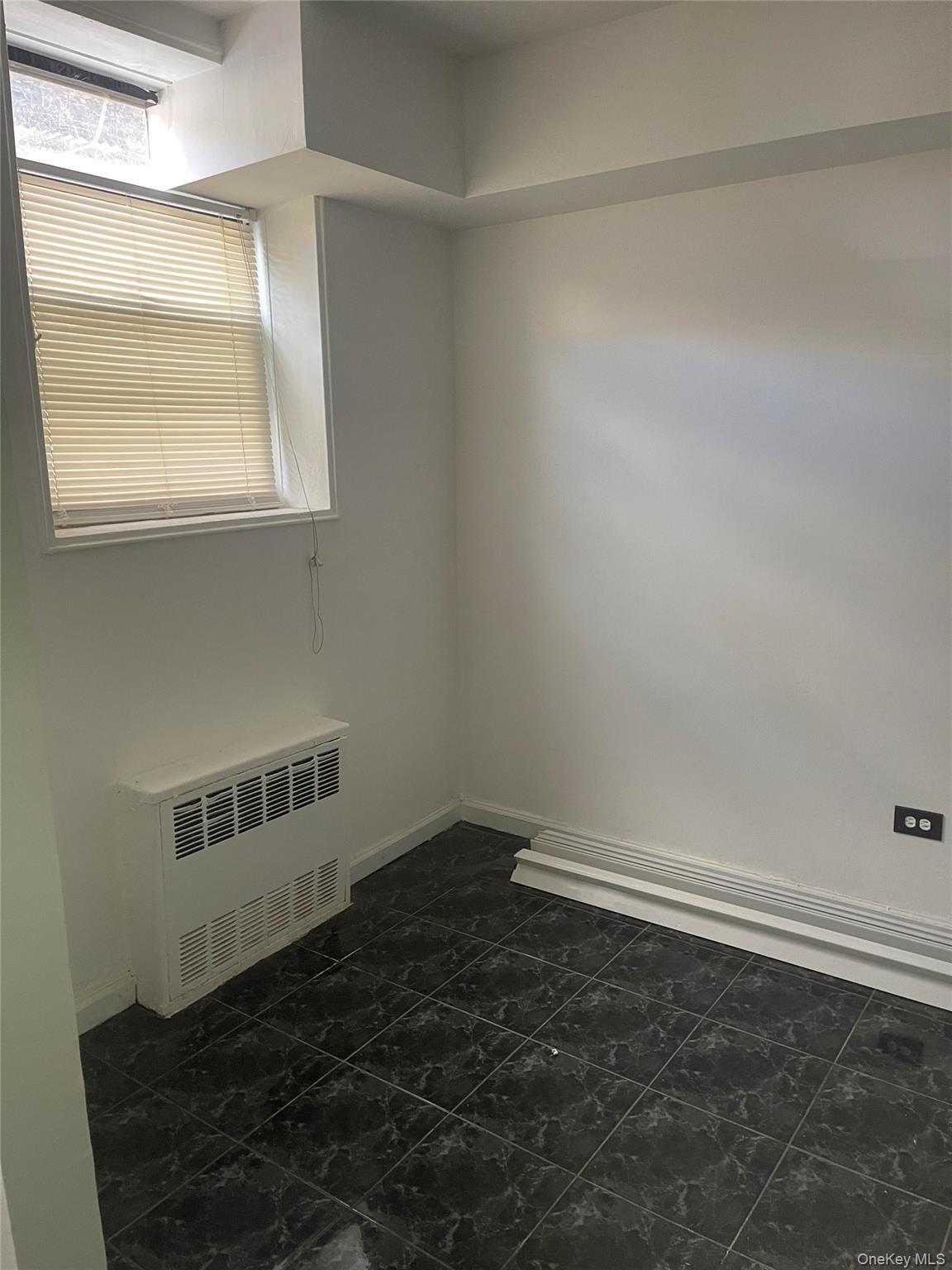 152-72 Melbourne Avenue, Unit LD Queens, NY 11367 - Photo 10 of 10 an empty room with a window