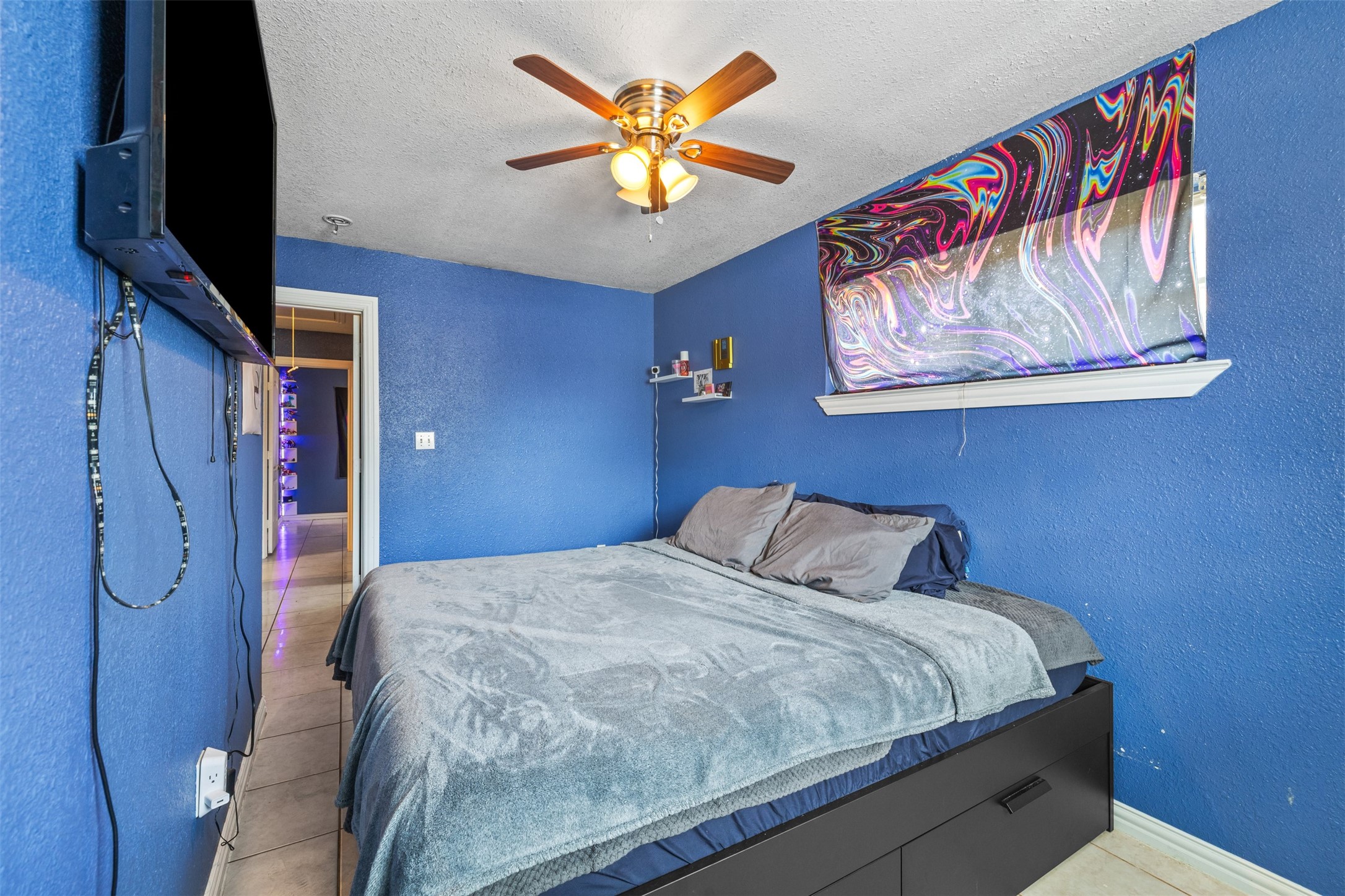 3367 Sadler Street Houston, TX 77093 - Photo 12 of 25 a bedroom with a bed and a flat screen tv