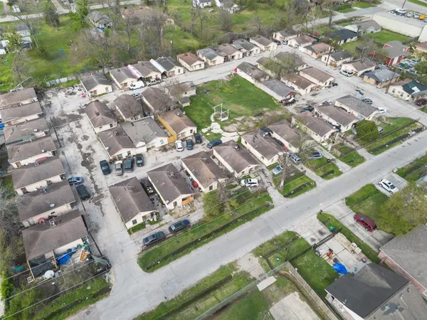 an aerial view of residential houses with outdoor space