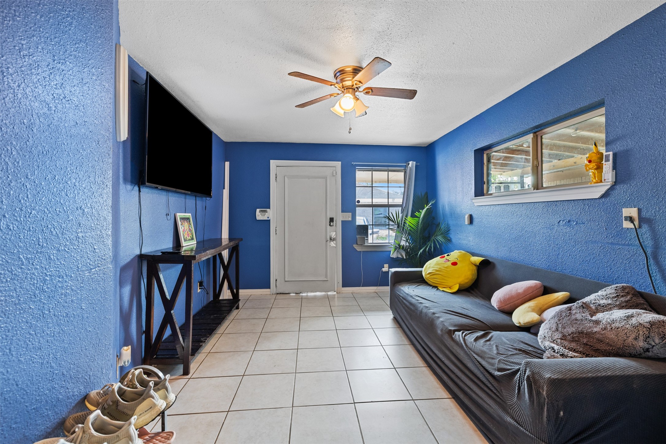 3367 Sadler Street Houston, TX 77093 - Photo 3 of 25 a bedroom with furniture and a flat screen tv