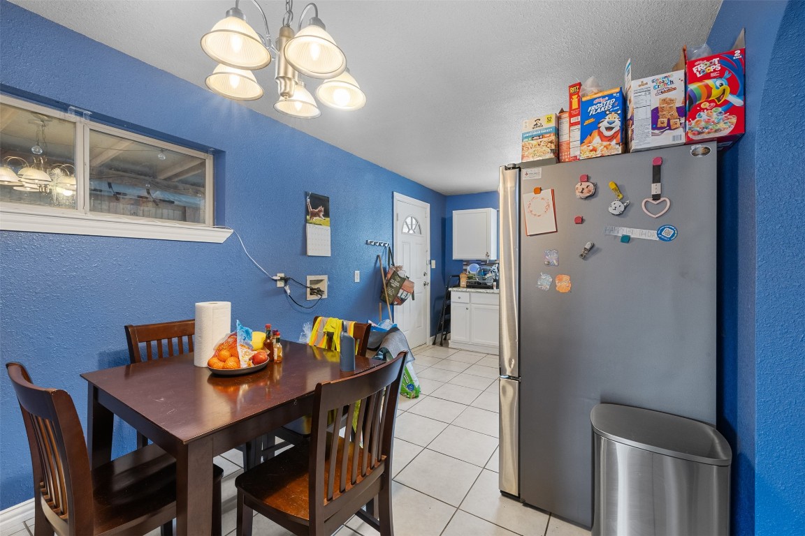 3367 Sadler Street Houston, TX 77093 - Photo 4 of 25 a view of a dining room with furniture wooden floor and a chandelier