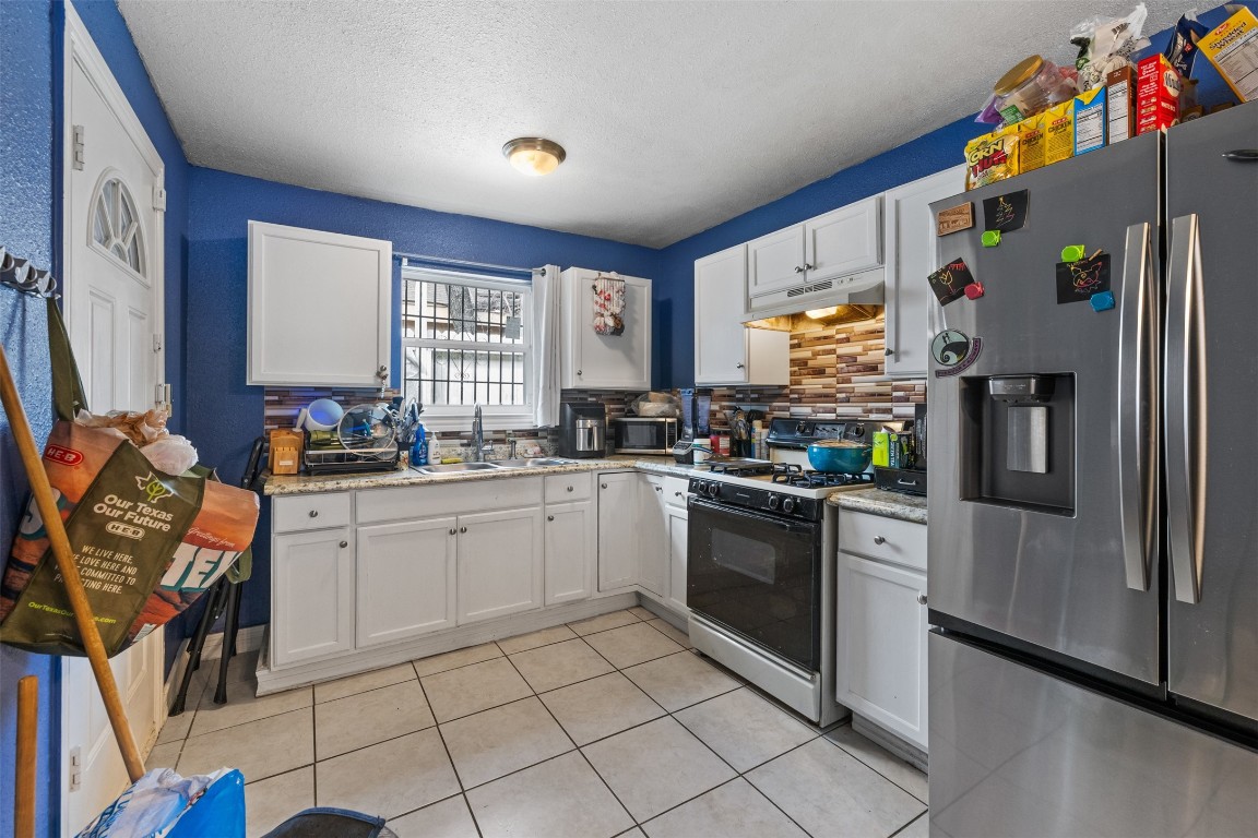 3367 Sadler Street Houston, TX 77093 - Photo 5 of 25 a kitchen with stainless steel appliances granite countertop a refrigerator sink and stove