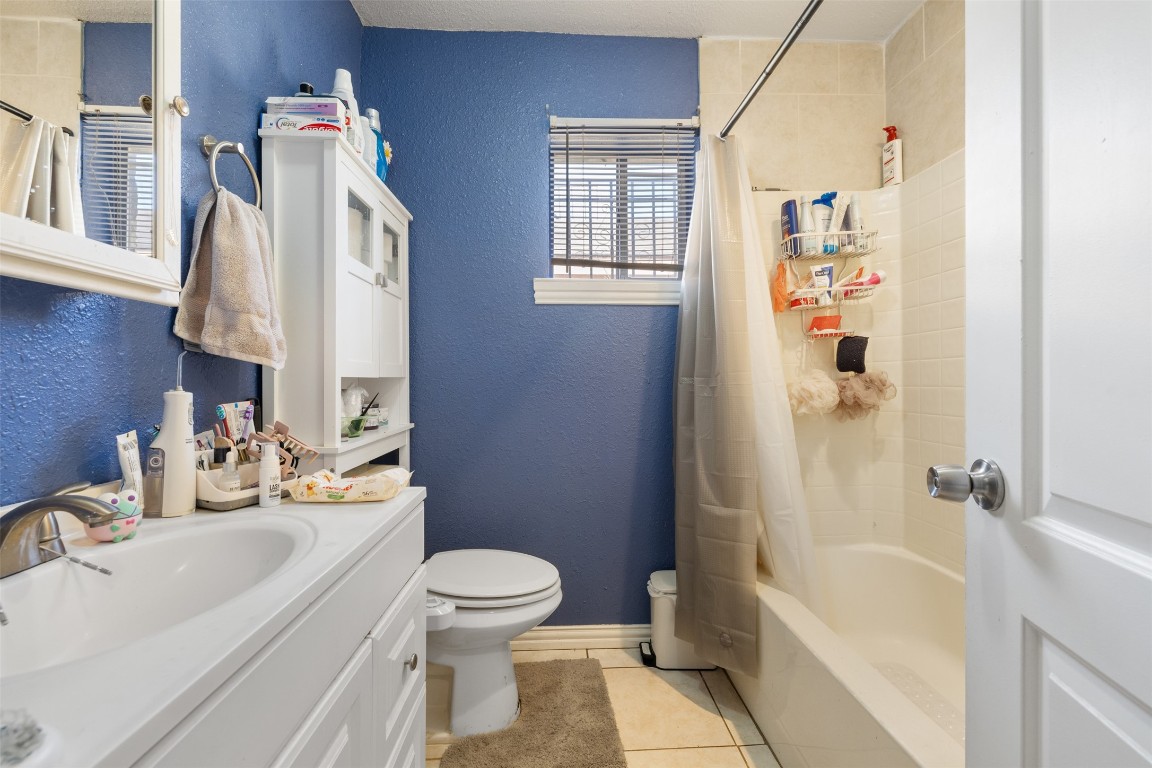 3367 Sadler Street Houston, TX 77093 - Photo 9 of 25 a bathroom with a sink a toilet and shower