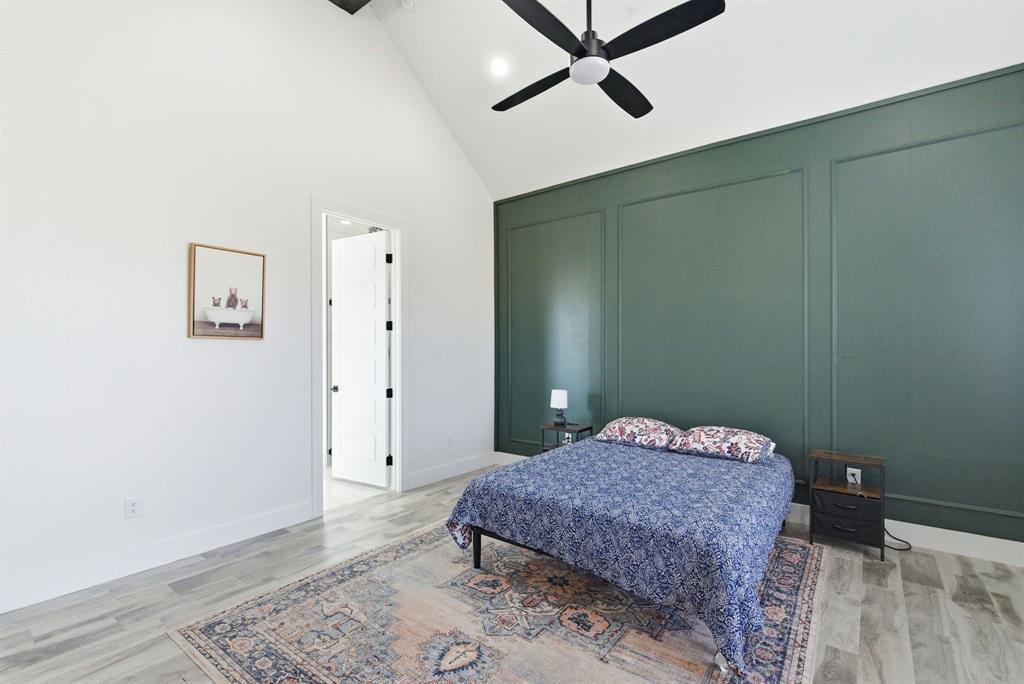 1024 Agnes North Springtown, TX 76082 - Photo 18 of 36 a bedroom with a bed and wooden floor