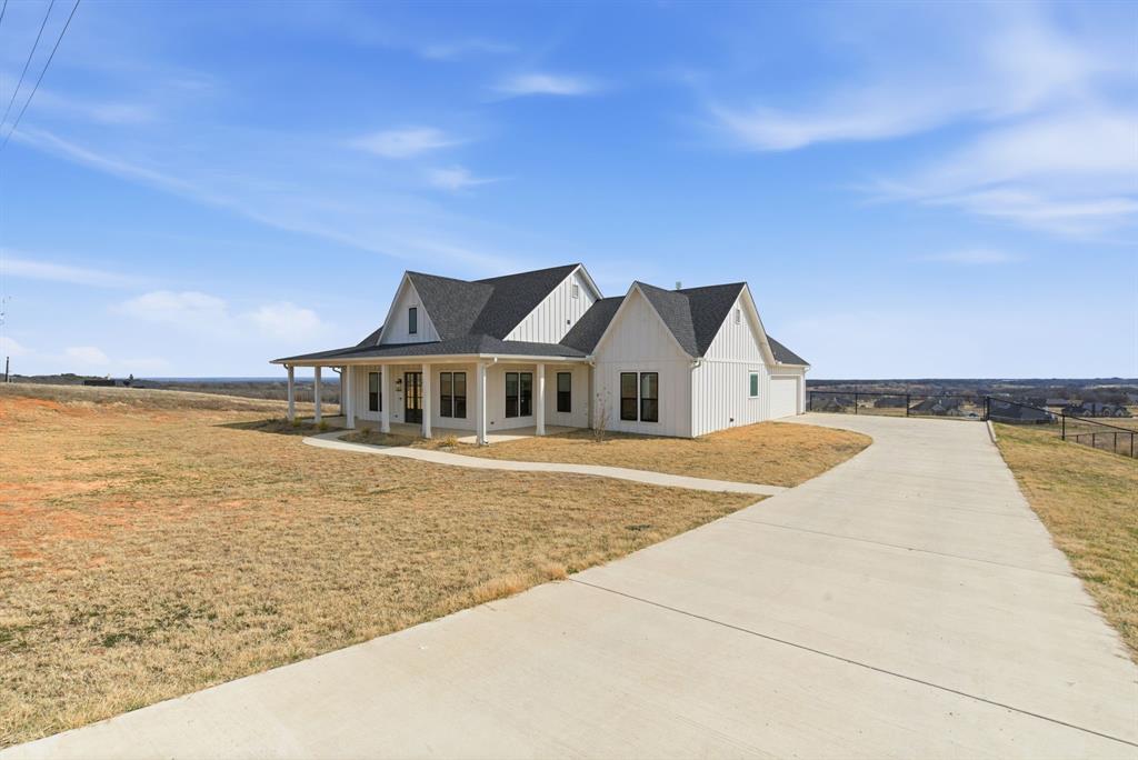 1024 Agnes North Springtown, TX 76082 - Photo 2 of 36 a front view of a house with a ocean view