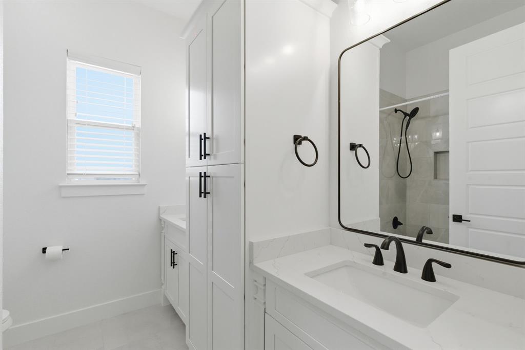 1024 Agnes North Springtown, TX 76082 - Photo 26 of 36 a bathroom with a sink and mirror with shower