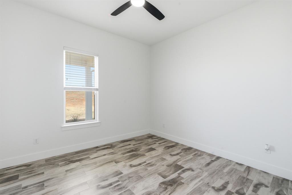1024 Agnes North Springtown, TX 76082 - Photo 28 of 36 an empty room with a window and ceiling fan