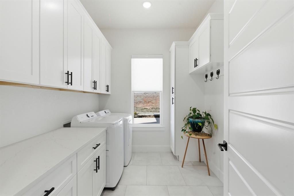 1024 Agnes North Springtown, TX 76082 - Photo 30 of 36 a utility room with cabinets washer and dryer