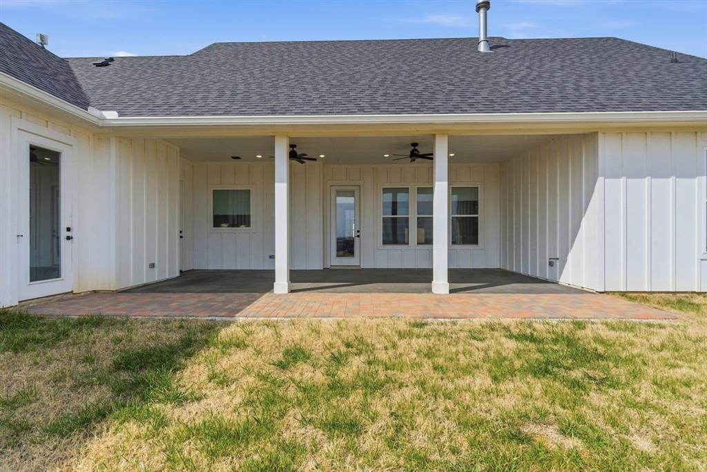 1024 Agnes North Springtown, TX 76082 - Photo 35 of 36 a view of a house with backyard and garage