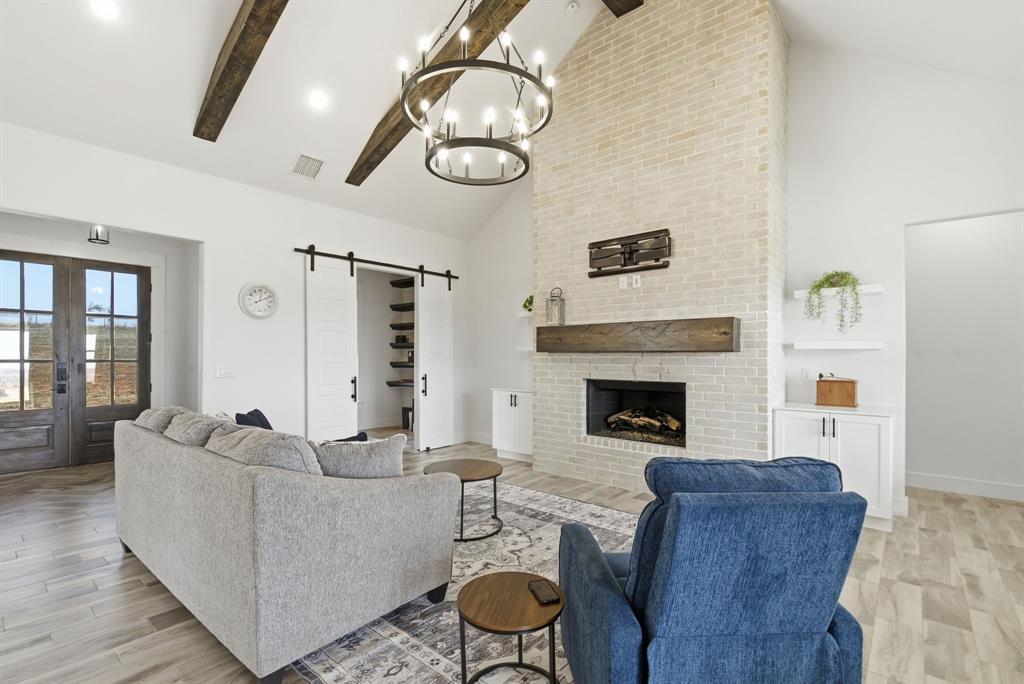 1024 Agnes North Springtown, TX 76082 - Photo 4 of 36 a living room with furniture and a fireplace