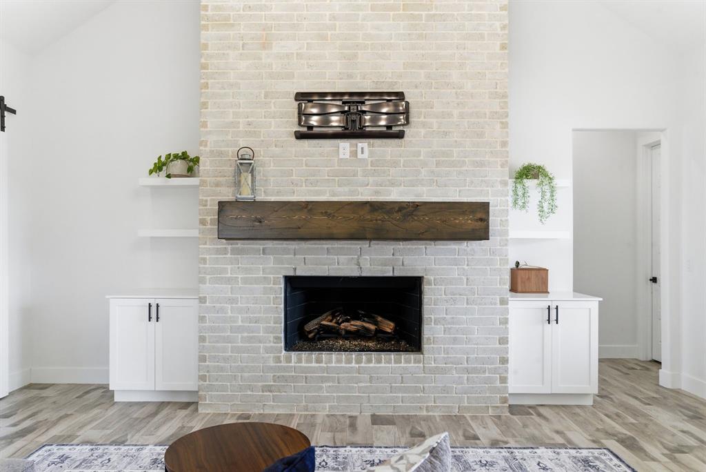1024 Agnes North Springtown, TX 76082 - Photo 5 of 36 a living room with furniture and a fireplace