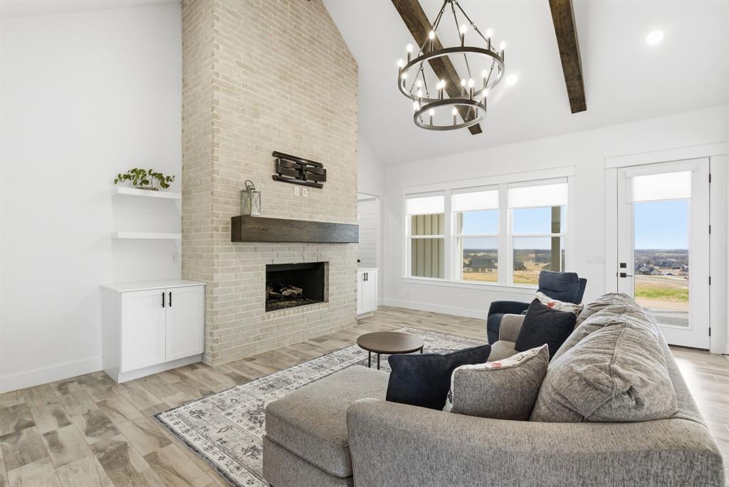 1024 Agnes North Springtown, TX 76082 - Photo 7 of 36 a living room with furniture and a fireplace