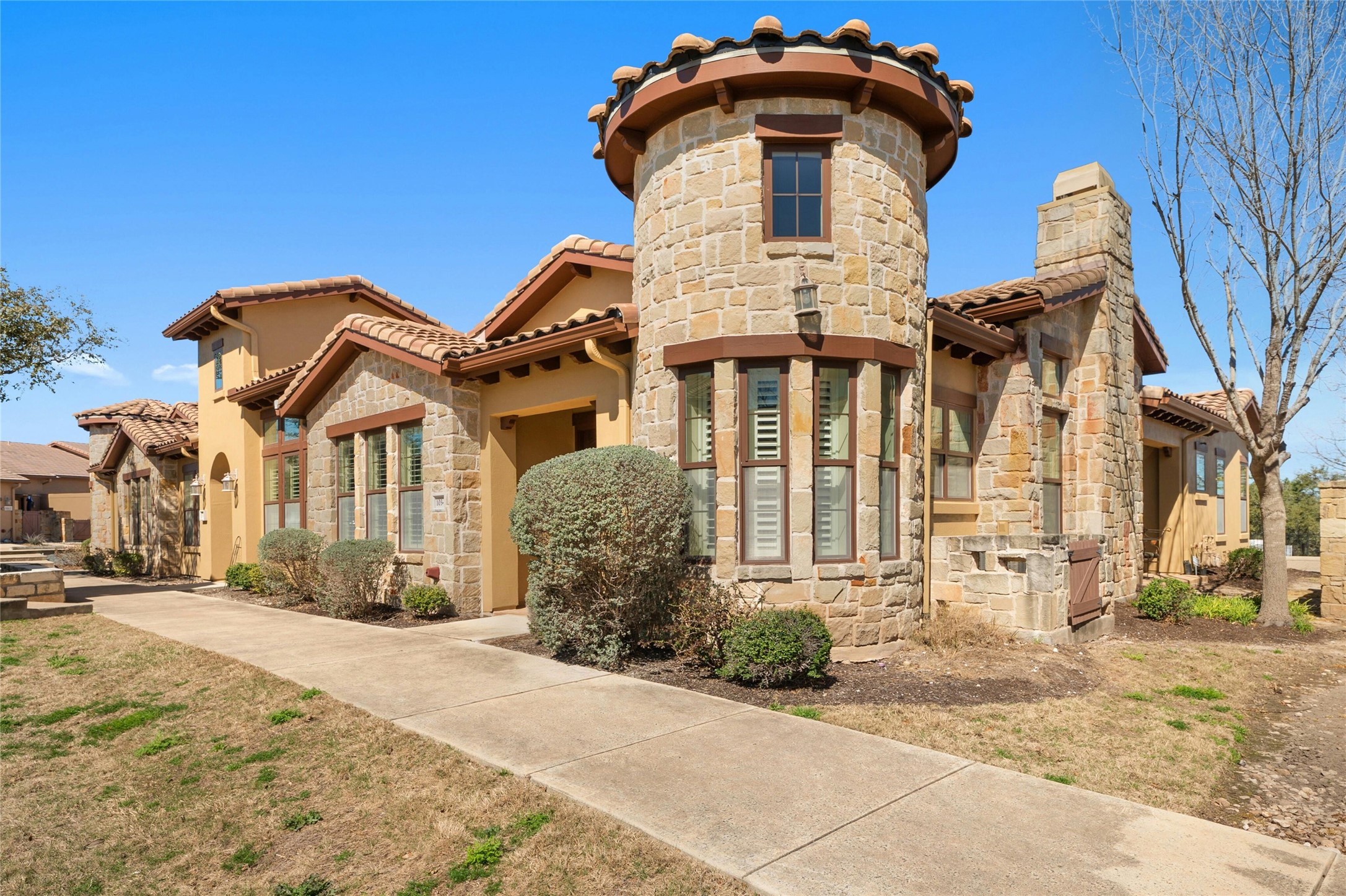 103 Rivalto Circle, Unit 3 Lakeway, TX 78734 - Photo 1 of 30 a front view of a house with a yard