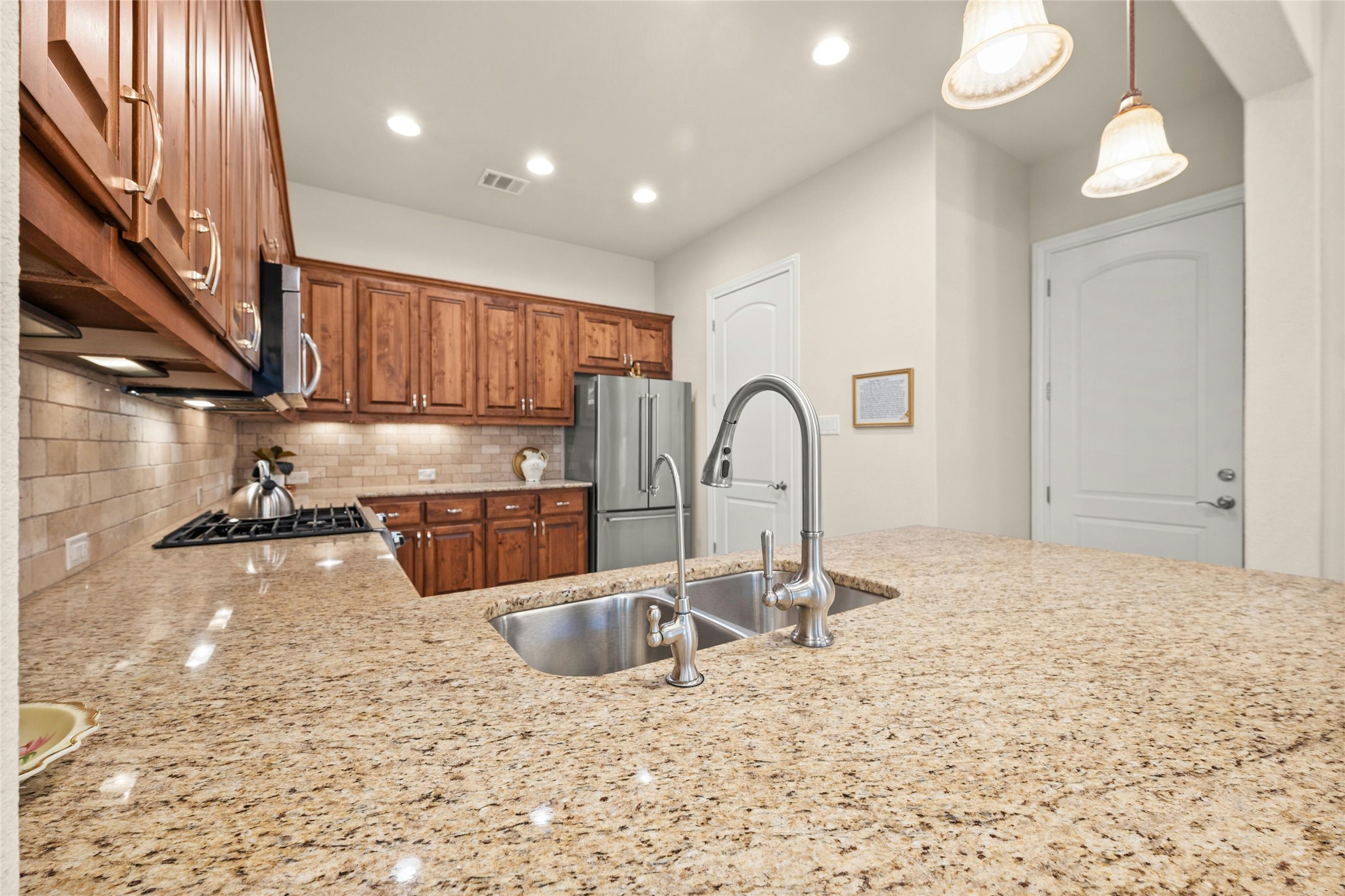 103 Rivalto Circle, Unit 3 Lakeway, TX 78734 - Photo 11 of 30 a kitchen with a sink and a stove top oven