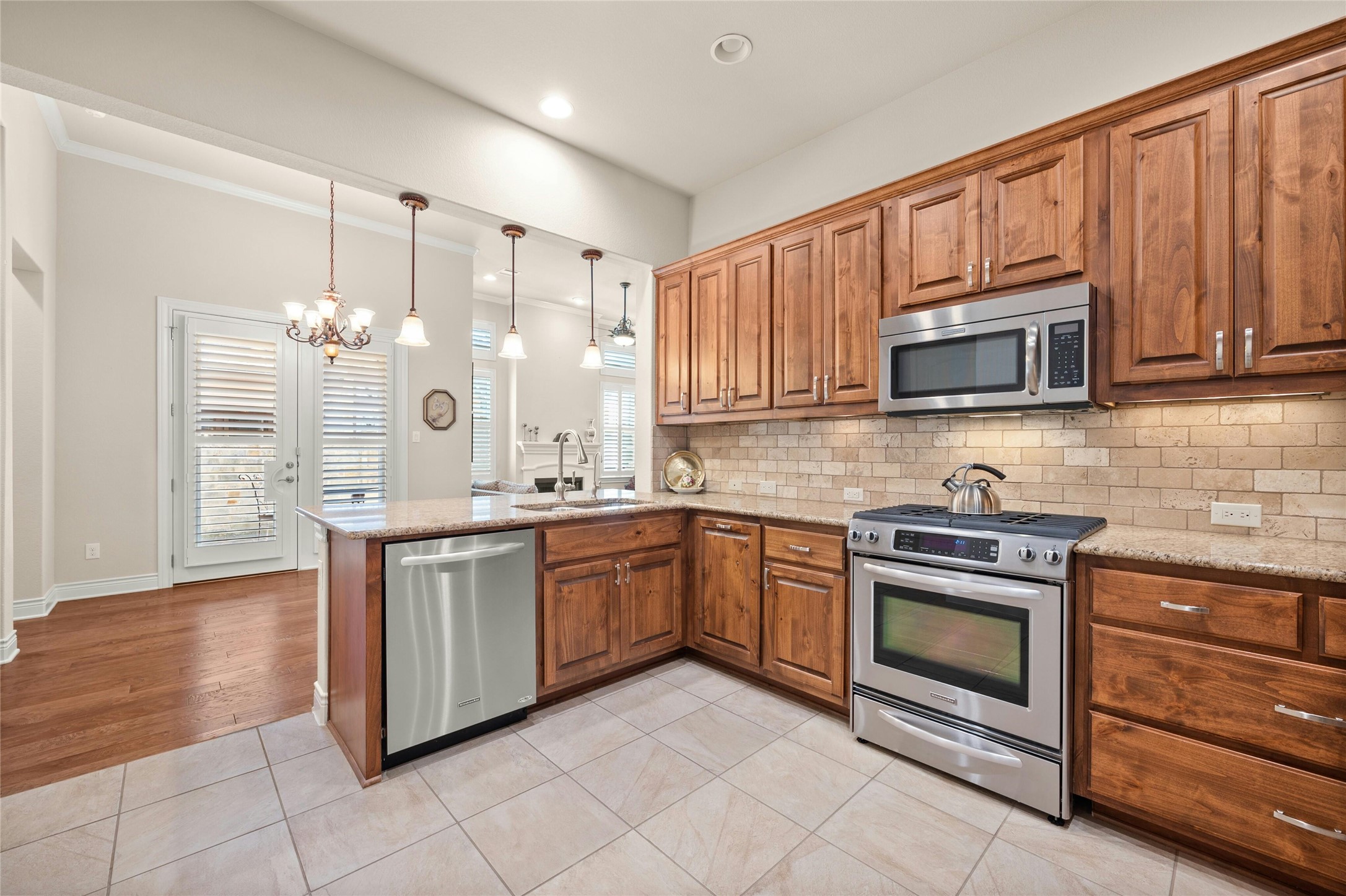 103 Rivalto Circle, Unit 3 Lakeway, TX 78734 - Photo 13 of 30 a kitchen with stainless steel appliances granite countertop a stove top oven microwave and cabinets