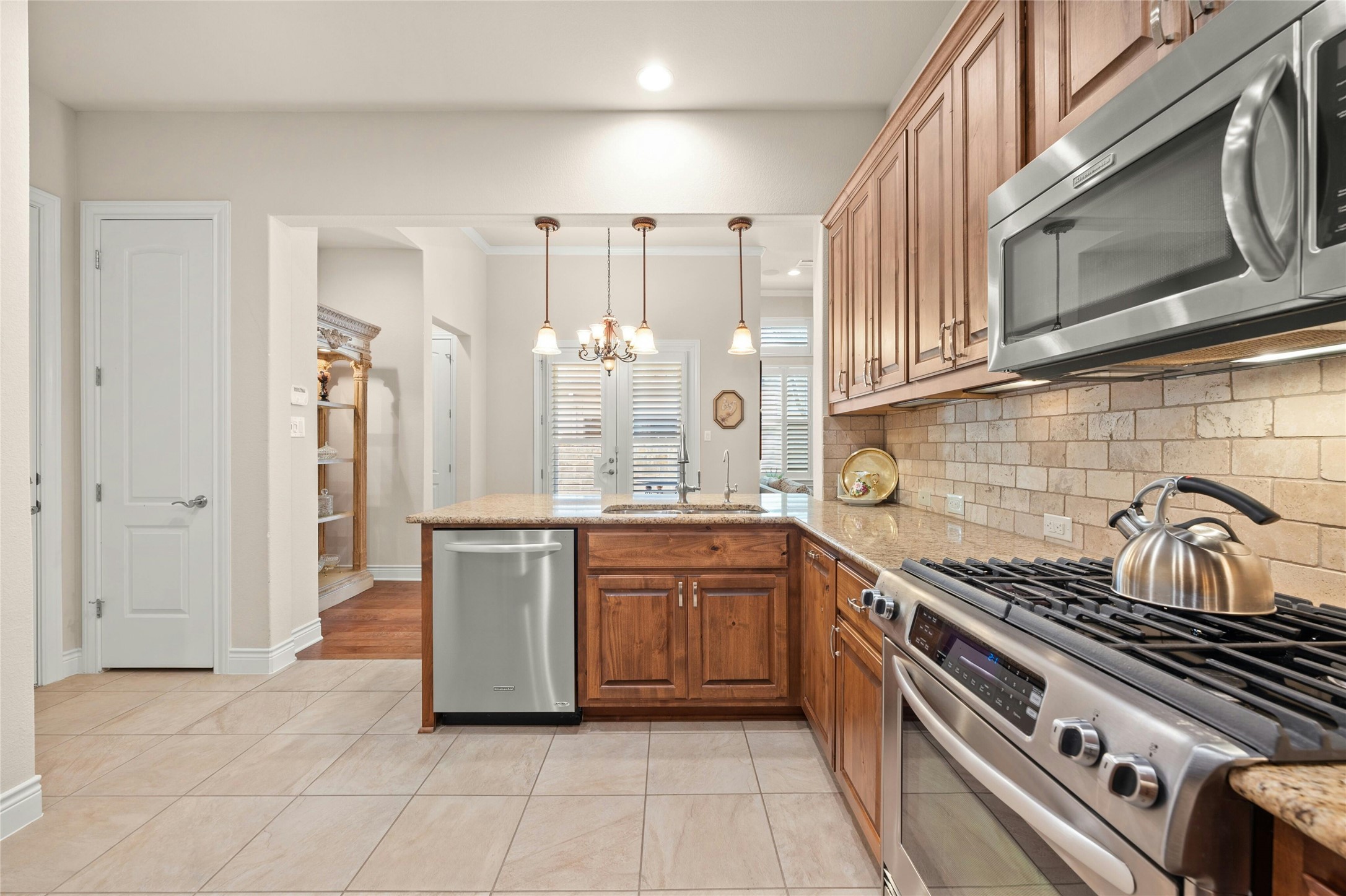 103 Rivalto Circle, Unit 3 Lakeway, TX 78734 - Photo 14 of 30 a kitchen with stainless steel appliances granite countertop a stove and a sink