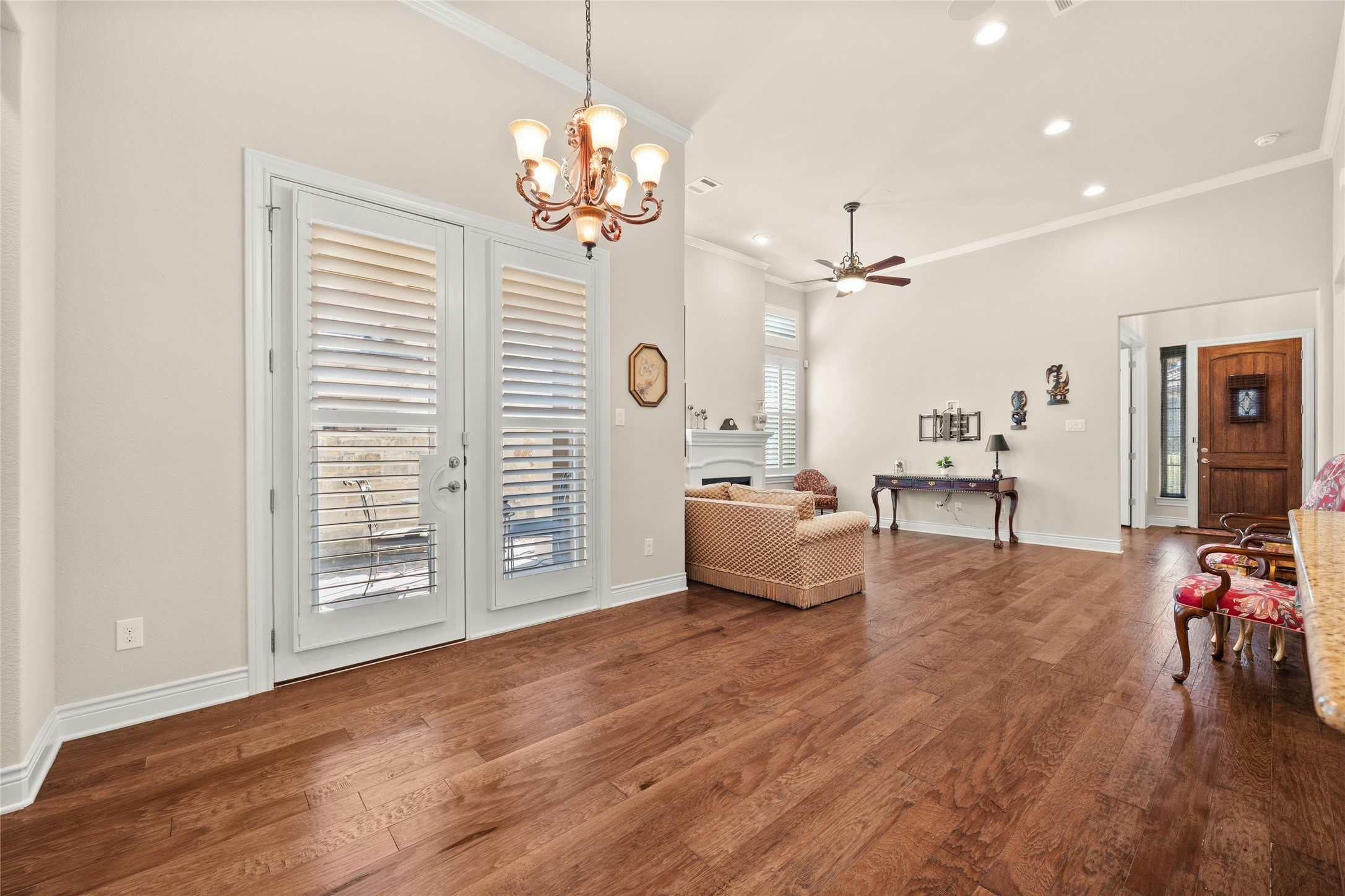103 Rivalto Circle, Unit 3 Lakeway, TX 78734 - Photo 15 of 30 a spacious bedroom with furniture and a chandelier