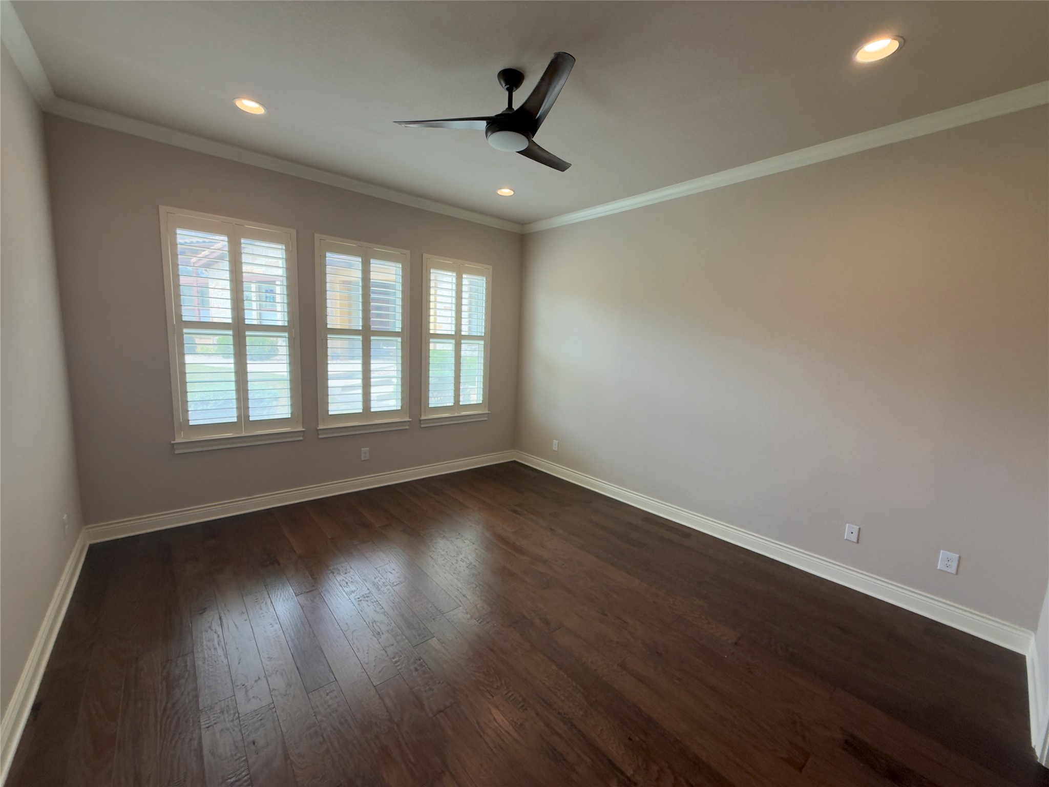 103 Rivalto Circle, Unit 3 Lakeway, TX 78734 - Photo 17 of 30 an empty room with wooden floor and windows