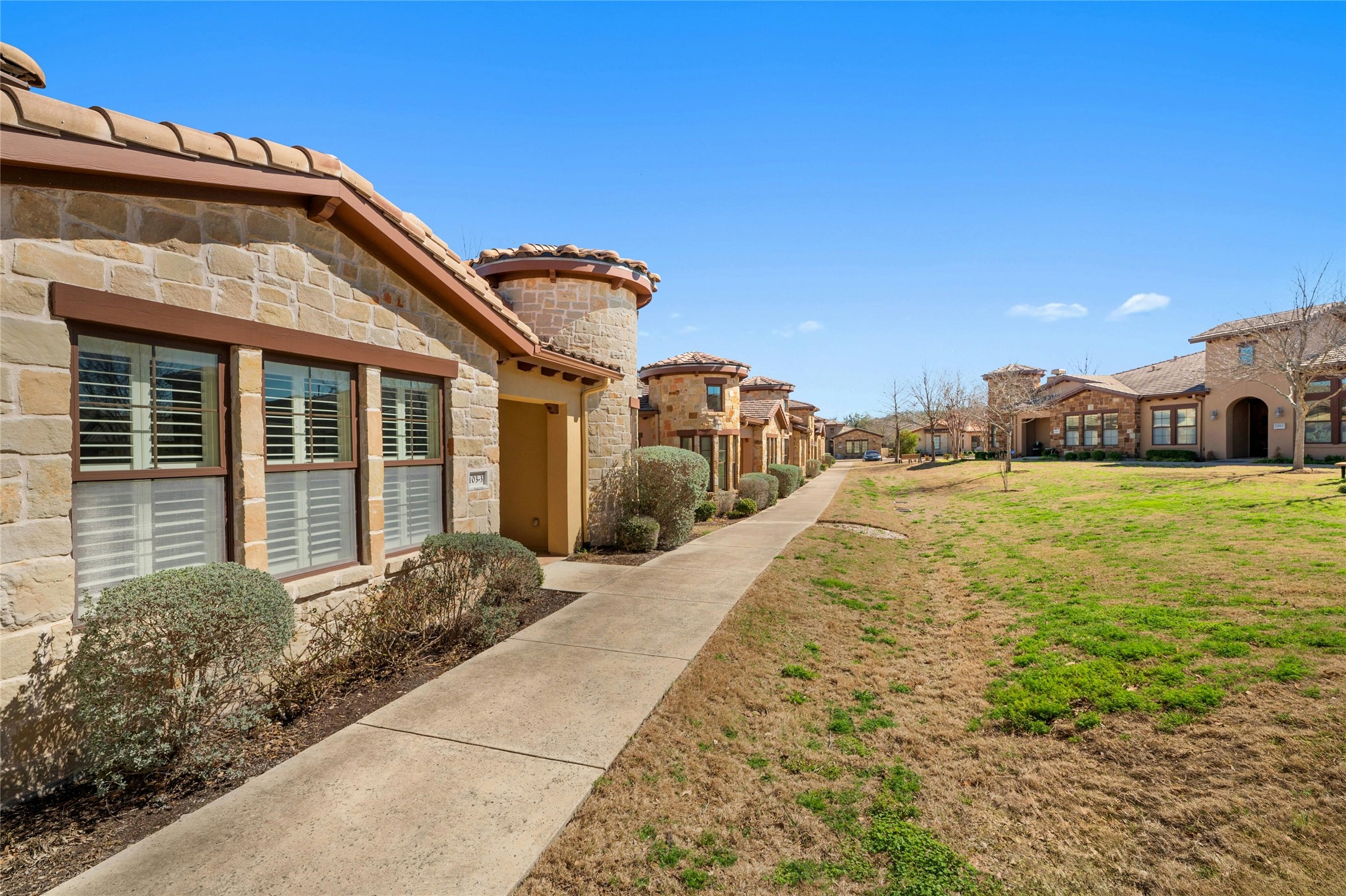 103 Rivalto Circle, Unit 3 Lakeway, TX 78734 - Photo 3 of 30 a view of a house with a yard