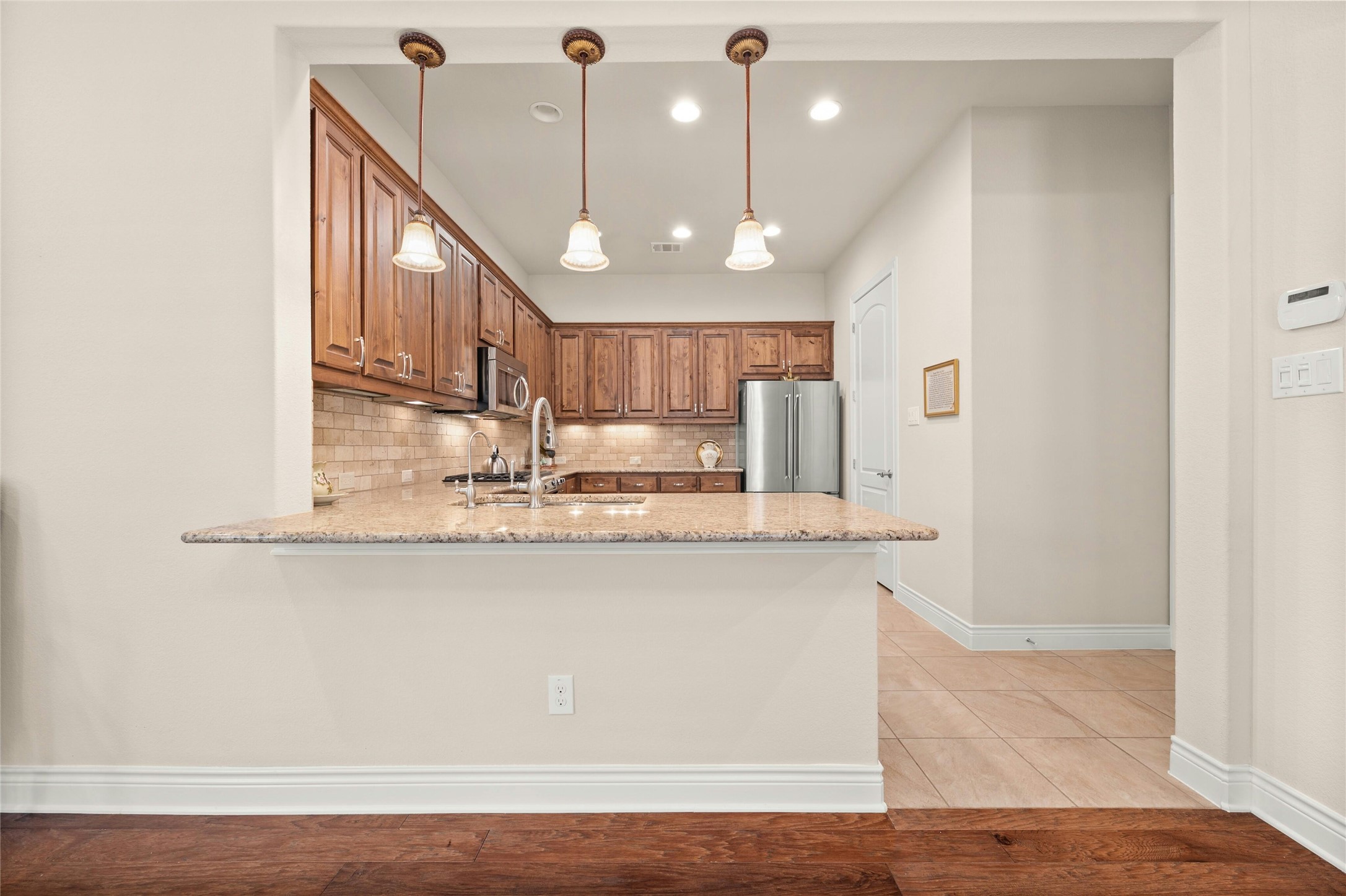 103 Rivalto Circle, Unit 3 Lakeway, TX 78734 - Photo 10 of 30 a view of kitchen with stainless steel appliances granite countertop cabinets and wooden floor
