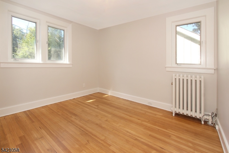10 Lincoln Street Glen Ridge, NJ 07028 - Photo 11 of 28 an empty room with wooden floor and windows