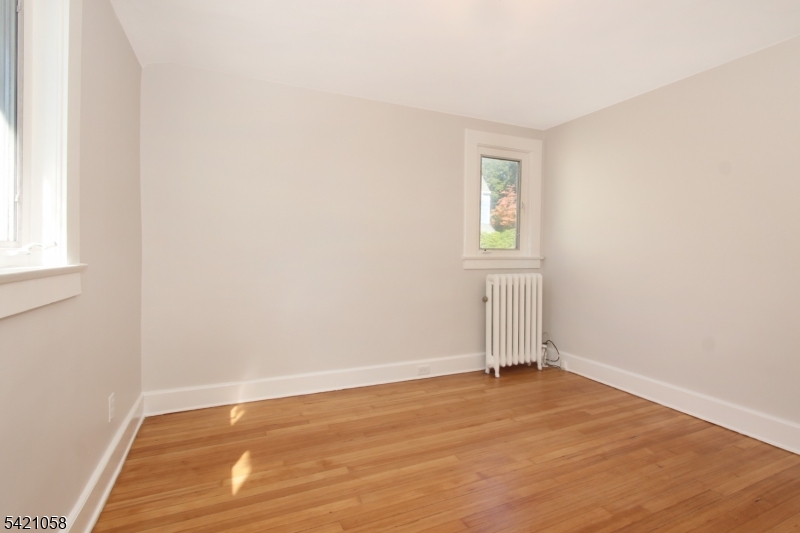 10 Lincoln Street Glen Ridge, NJ 07028 - Photo 12 of 28 an empty room with wooden floor and window