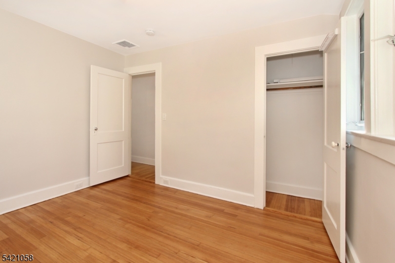 10 Lincoln Street Glen Ridge, NJ 07028 - Photo 13 of 28 a view of an empty room with wooden floor