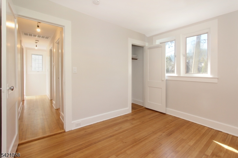 10 Lincoln Street Glen Ridge, NJ 07028 - Photo 14 of 28 an empty room with wooden floor and windows