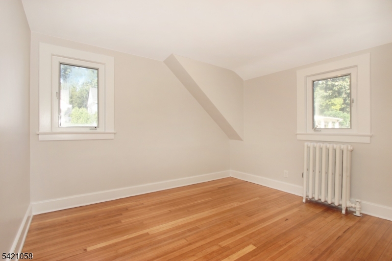 10 Lincoln Street Glen Ridge, NJ 07028 - Photo 15 of 28 wooden floor in an empty room with a window