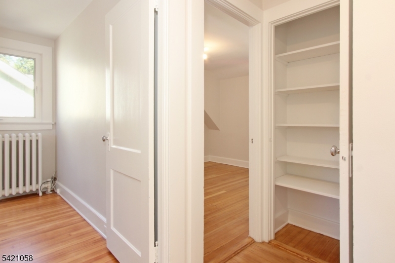 10 Lincoln Street Glen Ridge, NJ 07028 - Photo 20 of 28 a view of a hallway with wooden floor and closet