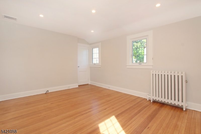 10 Lincoln Street Glen Ridge, NJ 07028 - Photo 7 of 28 an empty room with wooden floor and windows