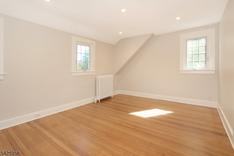 10 Lincoln Street Glen Ridge, NJ 07028 - Photo 8 of 28 an empty room with wooden floor and windows