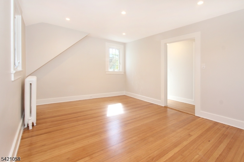 10 Lincoln Street Glen Ridge, NJ 07028 - Photo 9 of 28 an empty room with wooden floor and windows