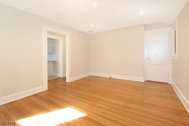 10 Lincoln Street Glen Ridge, NJ 07028 - Photo 10 of 28 a view of an empty room and wooden floor