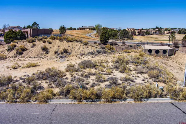 a street sign on a wall next to road