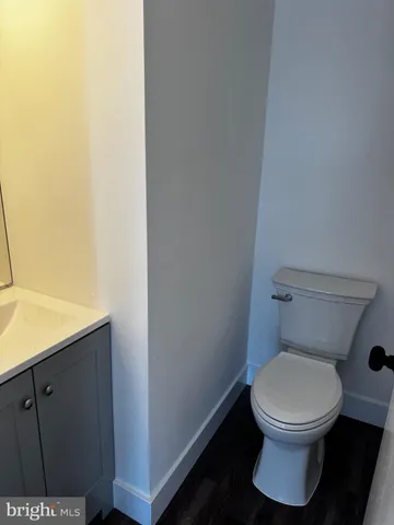 a white toilet sitting next to a shower