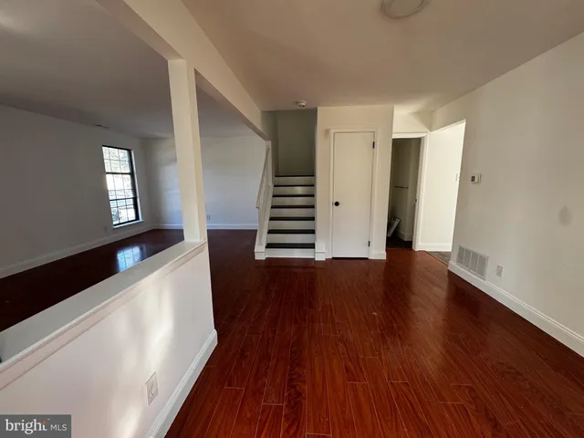 wooden floor in an empty room with a window