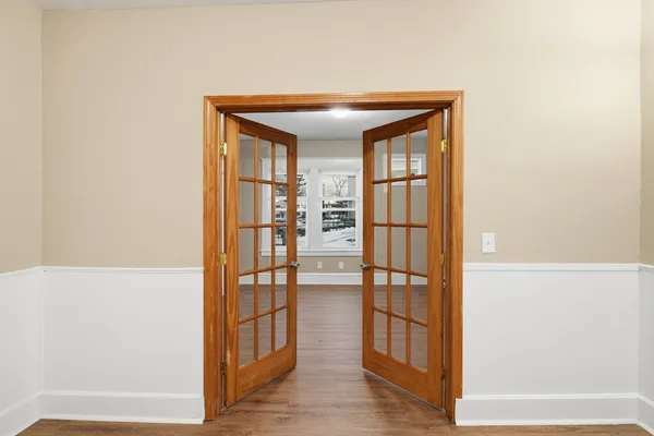 wooden floor in an empty room with a window
