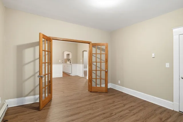 wooden floor in an empty room with a window