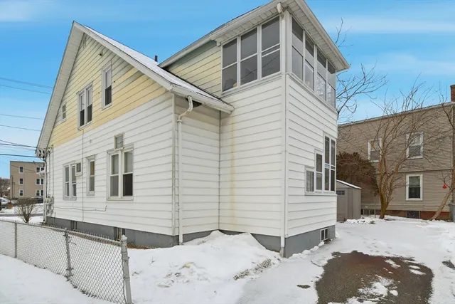 a view of a white house with a yard