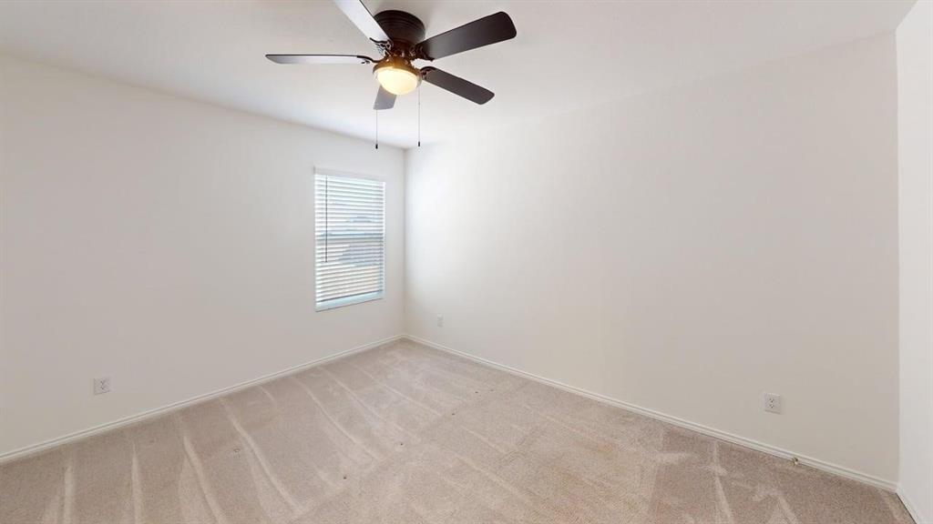 1623 Box Elder Road Forney, TX 75126 - Photo 12 of 22 an empty room with a window and a fan