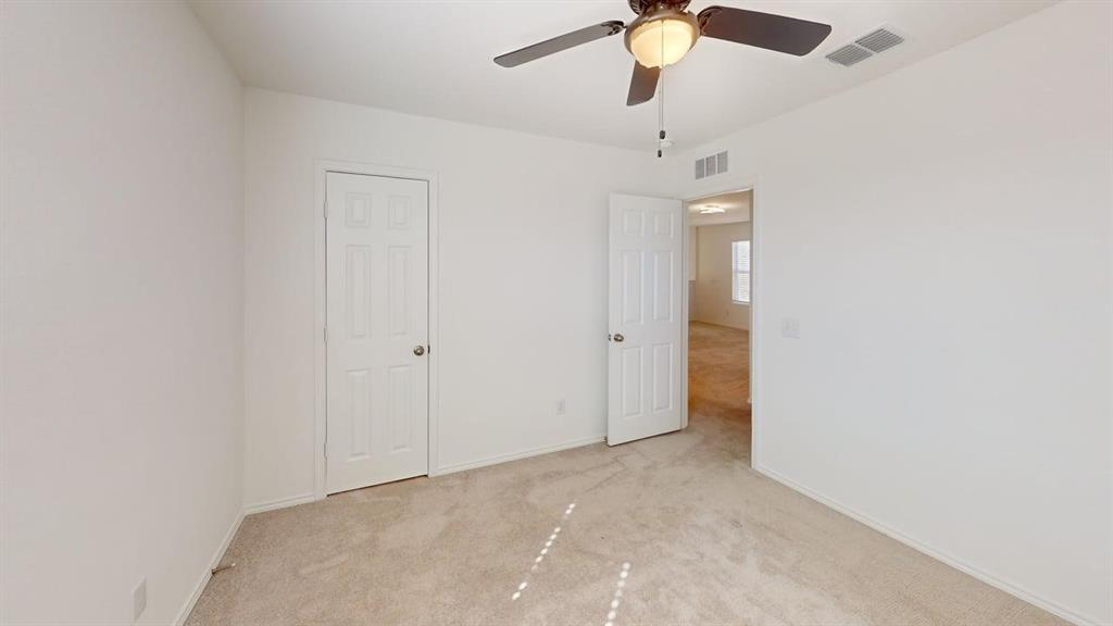 1623 Box Elder Road Forney, TX 75126 - Photo 13 of 22 an empty room with a chandelier fan and closet
