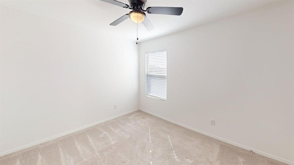 1623 Box Elder Road Forney, TX 75126 - Photo 14 of 22 an empty room with a window and a fan