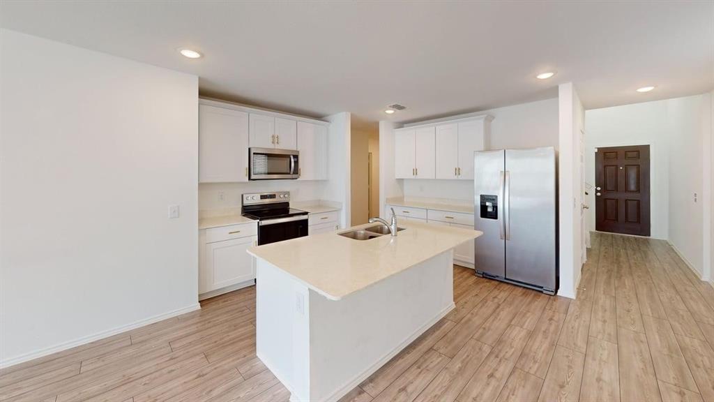 1623 Box Elder Road Forney, TX 75126 - Photo 4 of 22 a kitchen with stainless steel appliances a refrigerator and a stove top oven